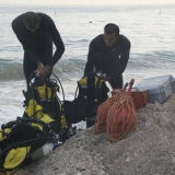 083   Divers prepare to help launch the ship