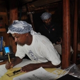 040   1st Mate Khamis Al Hamdani at work on the ship's charts