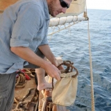 074   Alessandro Ghidoni collecting wash water in a canvas bucket