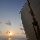 123   Sunset with Said Al Tarshi up the main mast setting a flag