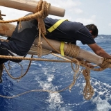 127   Said Al Tarshi does the risky work of fixing the storm sail to the yard