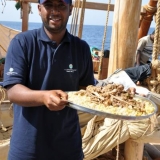 083   Yahya Al Faraji serves the Friday meal of goat and rice