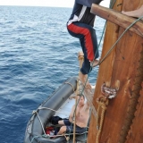 086   Said Al Tarshi and Eric Staples work to free a tangled line from the rudder