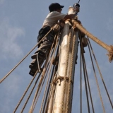 107   Eric Staples cleans the mast camera, high above deck