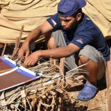 052   Fahad Al Shaibi repairs the chicken coop