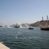 030   Tugs salute her with water jets