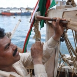 079   Babu Sankanran carves an inscription into the stern beam