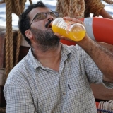 043   Adam Al Balushi  enjoys cold mango juice delivered by the Sri Lankan Navy