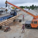 110   A crane unloads the new masts at Jewel's berth