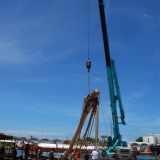 118   The old main mast is lowered to the quayside