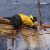 024   Ahmed Al Balushi ties a loose section of sail