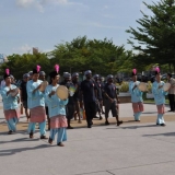064   Local dancers greet the crew as they come ashore