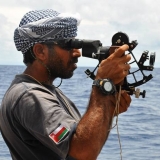 033   Captain Saleh uses the sextant to take a reading from the sun
