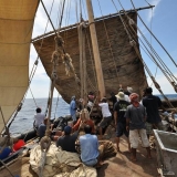 036   The palm leaf matting sail goes up on the main mast