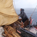 049   Adam Al Balushi helps lower the mizzen during another squall