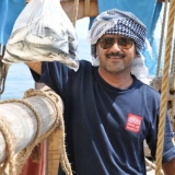 030   Adam Al Balushi with fresh fish from the Malaysian Coast Guard