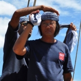 002   Vincent Wee gets some help with his traditional headgear
