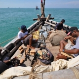 027   Crew members doing maintenance work as the ship is towed