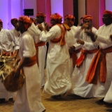 112   The Omani dance troupe arrives on the scene
