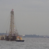 039   Two tugs are helping her into port
