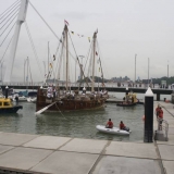 060   The tugs edge her round