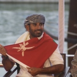 073   A beaming Capt Saleh listens to the speech