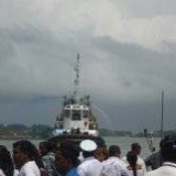 123   The port tug sprays coloured water as  a farewell to the Jewel