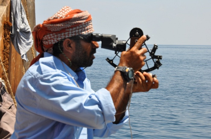 Captain Saleh Al Jabri uses the sextant to take a reading from the sun
