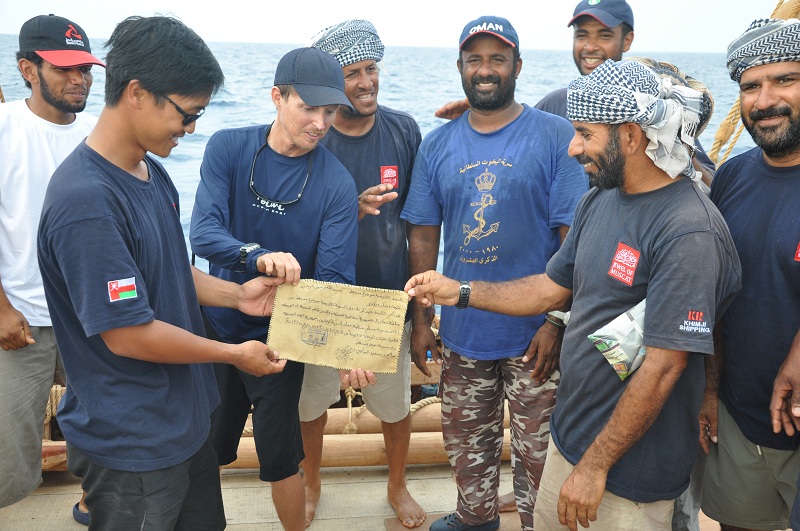  Singaporean crew member Jeff Khoo receives a certificate from Captain Saleh acknowledging Jeff's hard work during the voyage